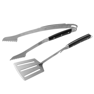 Black-handled stainless steel grill spatula and tongs. Perfect for grilling outdoors.