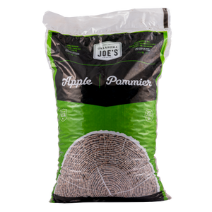 Black bag of Oklahoma Joe's mesquite wood pellets. A stack of bags is visible.