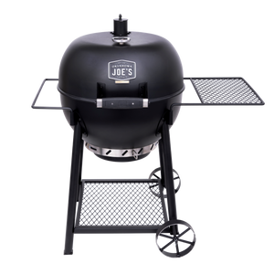 Black Weber Genesis E-310 gas grill with stainless steel accents. It has a side burner and warming rack.