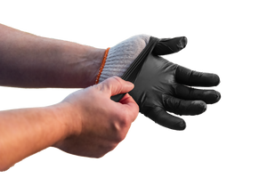 Black nitrile gloves being worn. They protect hands. Close-up view.