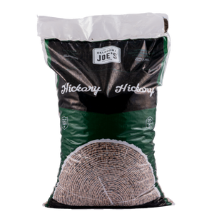Large bag of Kingsford charcoal briquettes. Black bag with red and white branding. Stacked neatly.