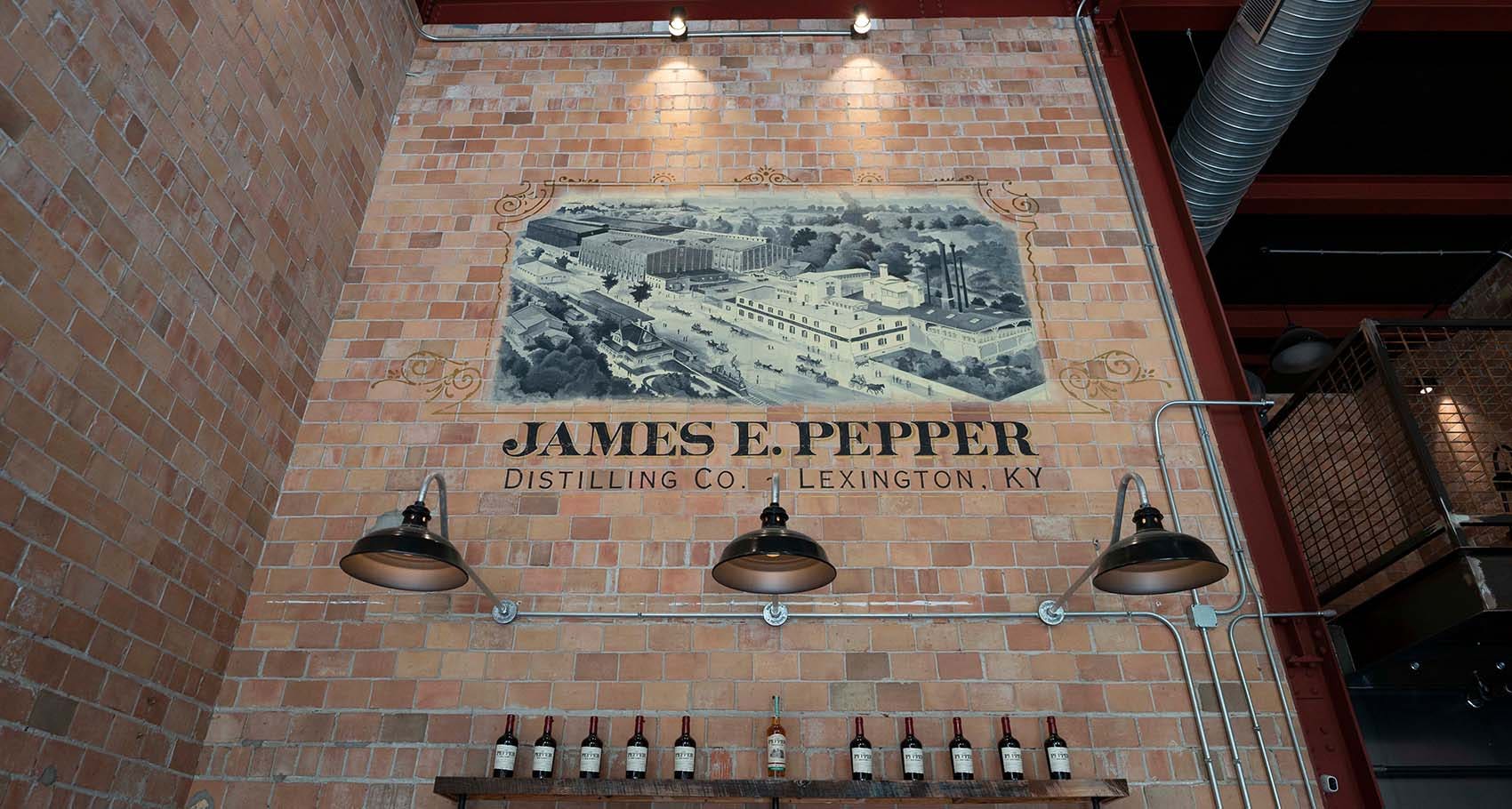 Inside shot of the Old Pepper Distillery with a ledge of bourbon bottles