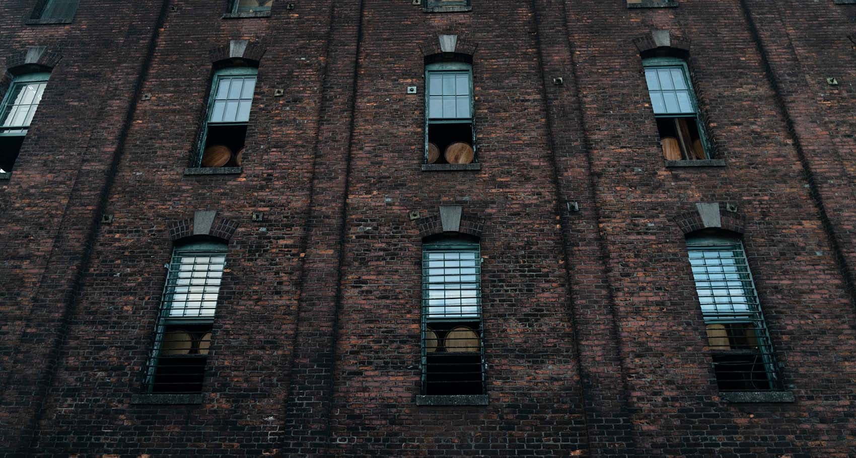 Buffalo Trace Distillery view of outside brick building with bourbon aging in barrels in windows