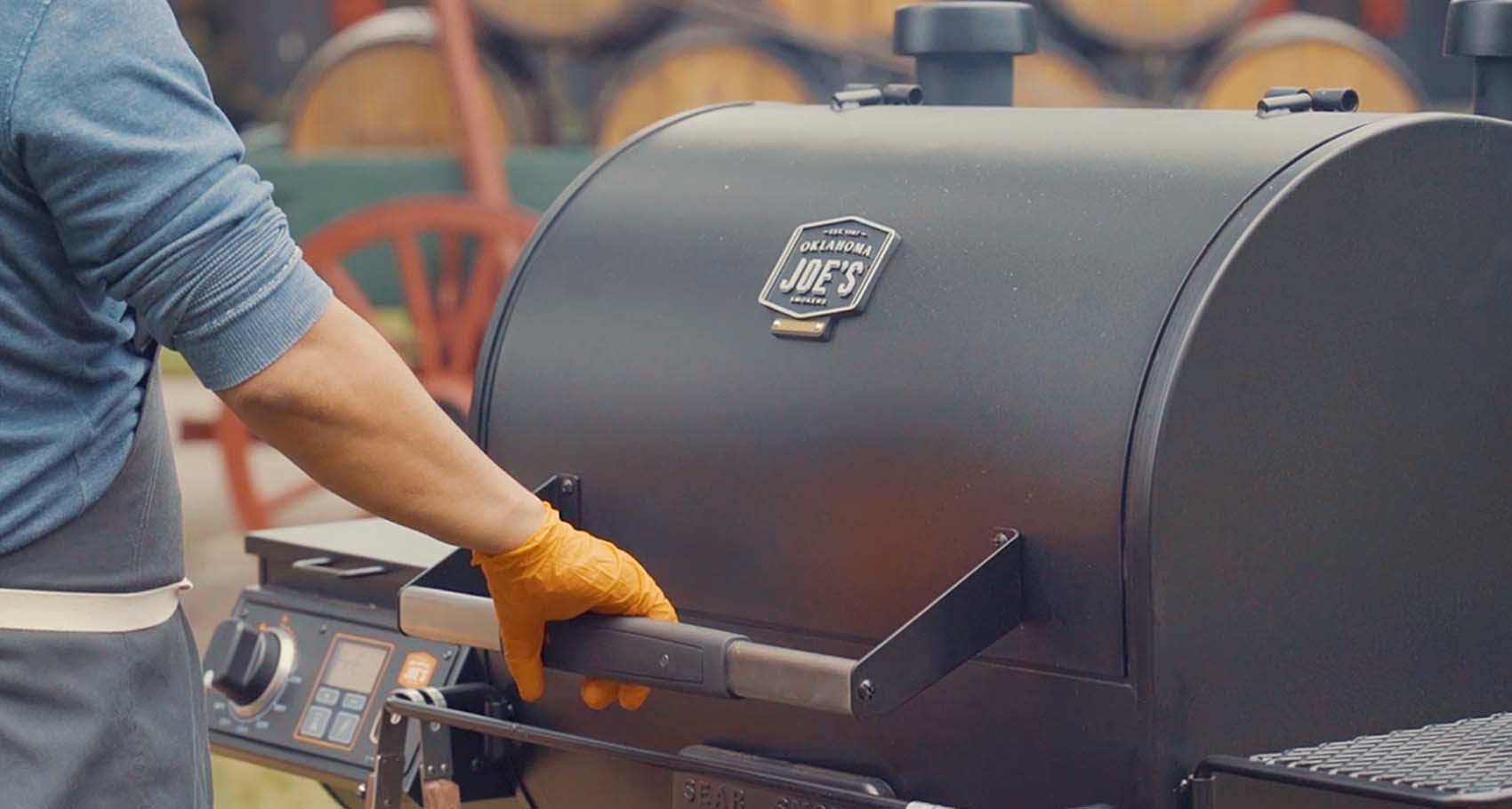 Chef Edward Lee smoking chicken wings in the Oklahoma Joe's® Rider DLX Pellet Grill